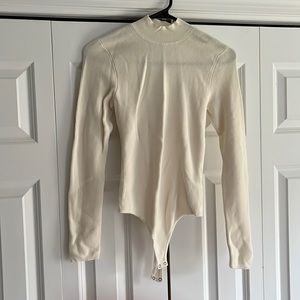 Cream colored long sleeve body suit